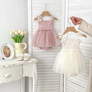 Detail of pink and cream baby girls' tutu romper with bow straps and layered mesh tulle