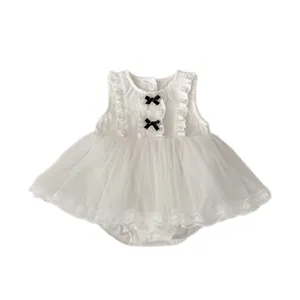White sleeveless baby tulle bodysuit dress with black bows and lace hem on white background