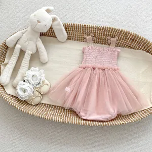 Pink infant mesh tutu dress with lace socks and bunny toy in a woven basket