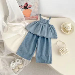 Detailed flat lay of girls light blue denim set with floral embroidery and ruffled straps