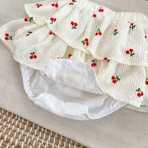 Detail of baby girl cherry embroidery tiered ruffles romper with snap buttons