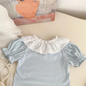 Detail of baby girl light blue ribbed top featuring exquisite white lace floral collar