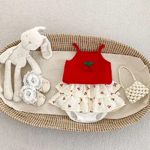 Close-up of baby girl cherry outfit with red camisole and tiered skirt in a basket