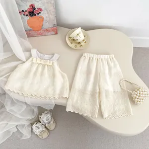 Detailed lace trim and polka dot texture on cream summer two-piece girls clothing set
