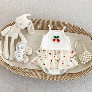 Detail of baby girl cherry vest set with ruffle skirt and plush bunny in a wicker basket