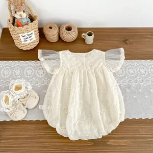 Detail of baby girl floral lace romper with mesh sleeves and matching lace shoes