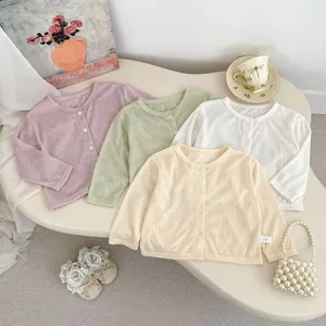 Flachbild von leichten Kinderstrickjacken in den Farben Rosa, Grün, Weiß und Beige