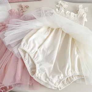 Detail of baby girl tulle romper dress featuring delicate lace bows and pleated chest elastic