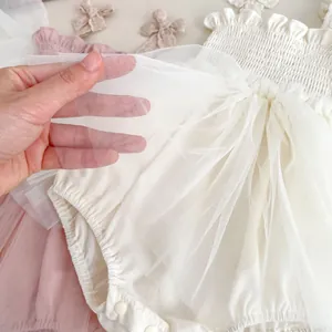 Elegant summer infant bodysuit dress with layered mesh tutu and bow detail in soft cream white