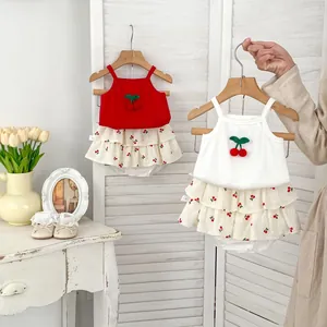 Detail of baby girl cherry pattern camisole and tiered ruffle skirt set in soft cotton