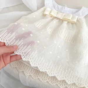 Toddler girl ivory sleeveless embroidered dress with bow detail and layered hem