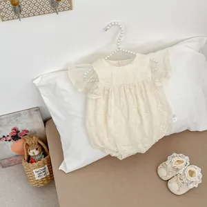 Detail of infant floral lace bodysuit with mesh flutter sleeves and fine embroidery