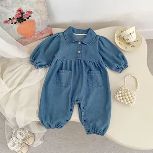 Long sleeve denim baby romper with lapel collar and wood buttons in a flat lay setup