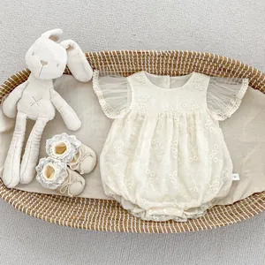 Detailed embroidery on baby romper set with mesh sleeves and matching lace bow shoes