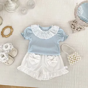 Baby girl summer set featuring light blue lace collar top and white heart pocket shorts