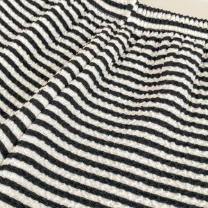 Pantaloni a gamba larga a righe per bambina in maglia testurizzata ed elastico in vita