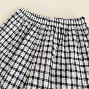 Detail of toddler girls' black and white gingham pants with elastic waist and fabric texture