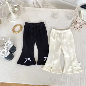 Détails du pantalon évasé pour bébés filles avec nœuds décoratifs noir et crème
