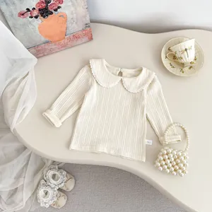 Cream ribbed long sleeve baby girl shirt with lace Peter Pan collar in retro setting