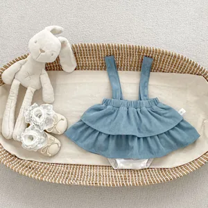 Detailed view of baby corduroy suspender dress set with lace trim and size label
