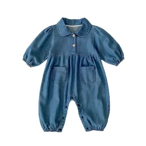 Baby denim romper with Peter Pan collar and wooden buttons on a clean white background