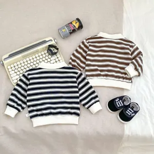 Flat lay of boys vintage striped sweatshirts in black and brown with ribbed cuffs