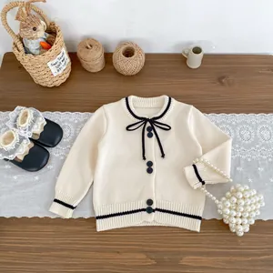 Girls' cream knit cardigan with black contrast trim and bow detail, two-piece autumn set