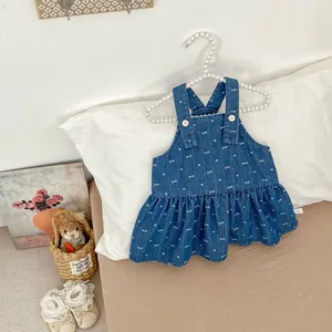 Detail of baby denim dress with bow print on pearl hanger showing size 73 label