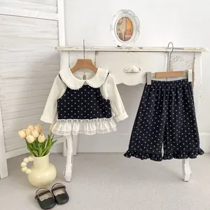 Three-piece floral girls outfit with white ruffled top and navy blue flower trousers
