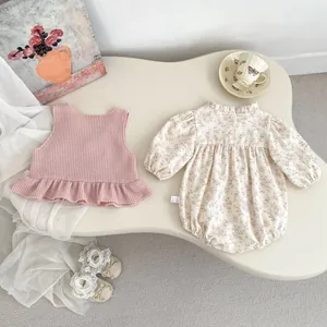 Detail of baby floral bodysuit and pink ruffled vest set with cute cherry patterns