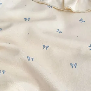 Baby girl fall set featuring off-white ribbed long sleeve top with blue bow patterns