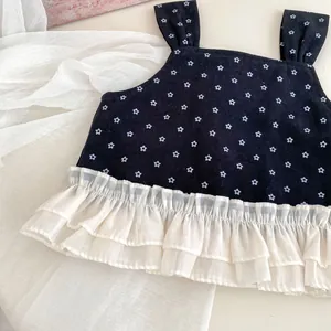 Detail of toddler girls floral vest featuring double-layered white pleated lace hem