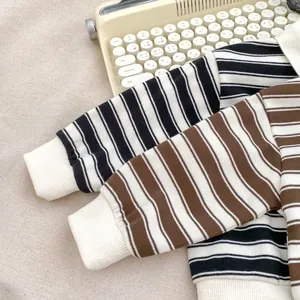 Detail of striped long-sleeve sweatshirts for boys with elastic ribbed cuffs on fabric