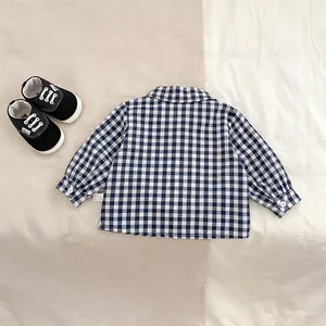 Detailed view of long-sleeve blue plaid baby shirt with premium cotton texture and buttons