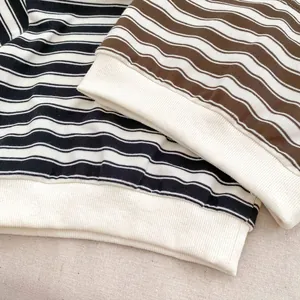 Close-up of striped cotton sweatshirts with ribbed cuffs in black and brown colors