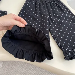 Detail of floral toddler leggings featuring elastic waist and delicate ruffled hem edges