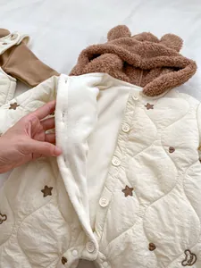 Detail of quilted baby romper with warm fleece lining and cute bear ear hood