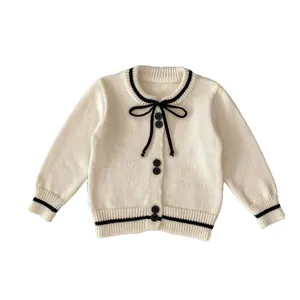 Girls cream knit cardigan with black contrast stripes and bow detail, autumn style