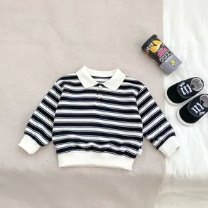 Detail of boys' striped long sleeve polo shirt with white lapel and ribbed cuffs