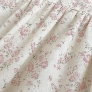 Close-up of floral cotton fabric with pink cherry prints and soft ruched texture