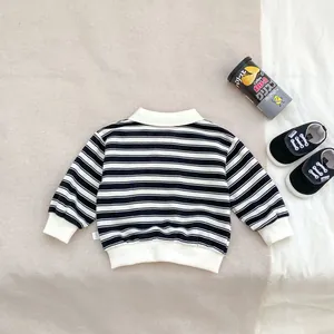 Detail of striped long-sleeve polo shirt for boys with ribbed collar and cuffs