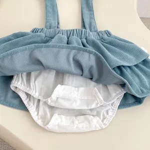 Detail of baby blue corduroy skirt showing elastic waist and snap buttons on inner romper