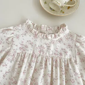 Detail of floral baby top with ruffled collar and pleated chest in vintage style