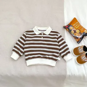 Detail of baby striped cotton polo shirt with white collar and size 73 label