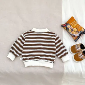 Close-up of boys striped long-sleeve polo shirt showing collar and ribbed cuff details