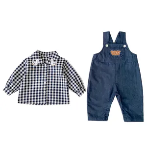 Infant boys' two-piece set featuring plaid shirt and navy blue overalls with duck embroidery