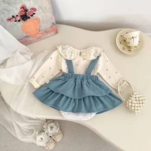 Detailed macro view of vintage baby girl outfit with corduroy dress and floral top