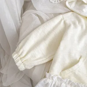 Détail du sweat à capuche pour bébé avec oreilles de lapin, ourlet à volants et tricot