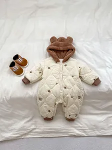 Detailed quilted texture and bear ear hood on white newborn thick romper