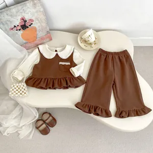 Close-up of girl's autumn outfit with ruffle trim, lace collar, and wide-leg trousers